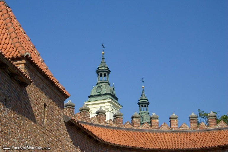 Faces of Warsaw - Roof and pillars of the Barbican with towers of the Holy Spirit Church on Freta Street